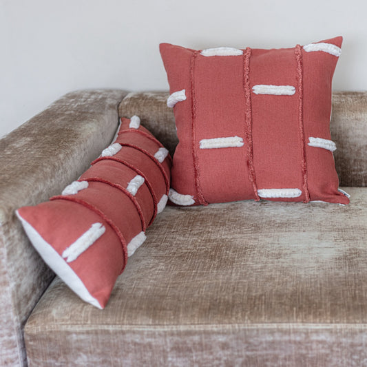 Red Bohemian style rectangle pillow and square pillow on couch