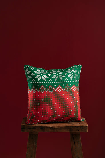 red and gren pillow cover on wooden chair with red backgound.