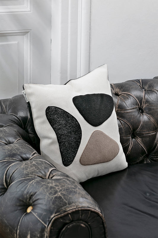 Handmade Minimalist Leticia pillow cover on a black sofa  