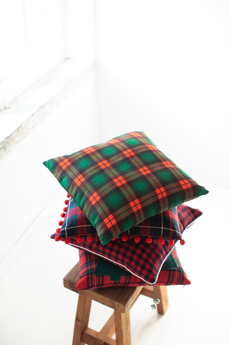 Classic tartan plaid pillow cover adding holiday charm to a cozy living room setting.